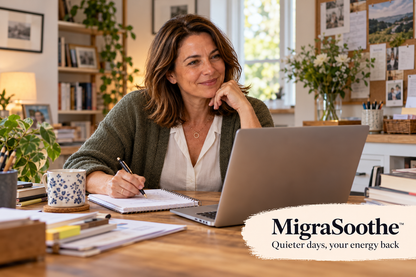 The same woman around 45 learning and working at her laptop in her lived-in home office.